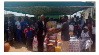 Rev Isaac Mensah, Senior Pastor, Fountain Gate Chapel presenting gifts to Teshie orphanage home