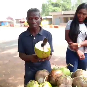 The blind man dehusking the coconut for a customer