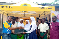 A student receiving a laptop