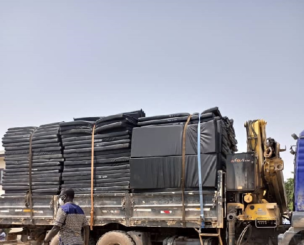 A truck loaded with mattresses