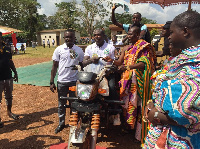 Akrofuom district's overall best farmer, Mr. Richard Kodie being given his tricycle