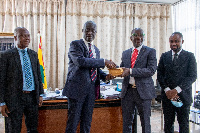 Mr. Kwetey( second right) presenting the cash to Mr Opoku Agyeman ( second left)