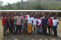 Airtel Ghana Employees in a Pose with the Heads and Employees of Adaklu Abuadi School