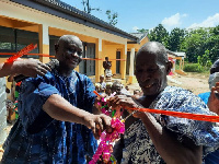 DCE Opoku Nyame (left) helps with the tape cutting ceremony