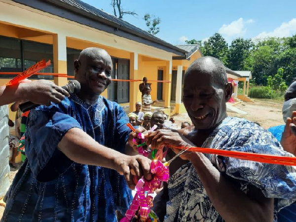 DCE Opoku Nyame (left) helps with the tape cutting ceremony