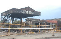 People looking at the burnt filling station