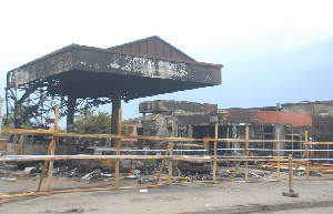 People looking at the burnt filling station