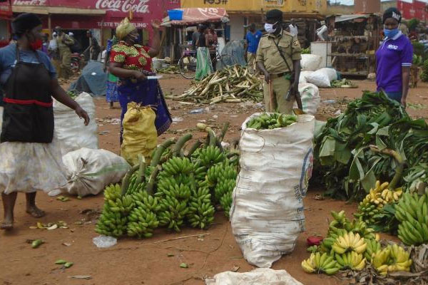 A policeman orders vendors to leave Balikyewunya Market in Luweero town