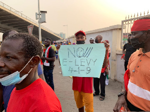 A participant of the demonstration holding up a placard