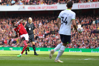 Partey curls the ball into the Spurs net