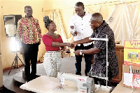 Miss Felicity Oppong (2nd left) receiving a sewing machine as part of her package