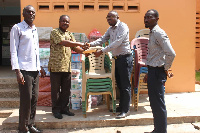 Yaw Asante receiving the items on behalf of the Assembly during the presentation