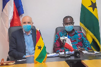 Dr Joseph Siaw Agyepong sitting next to Phillippe Hardouin