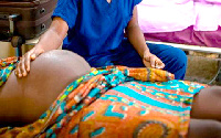 A pregnant woman on a hospital bed