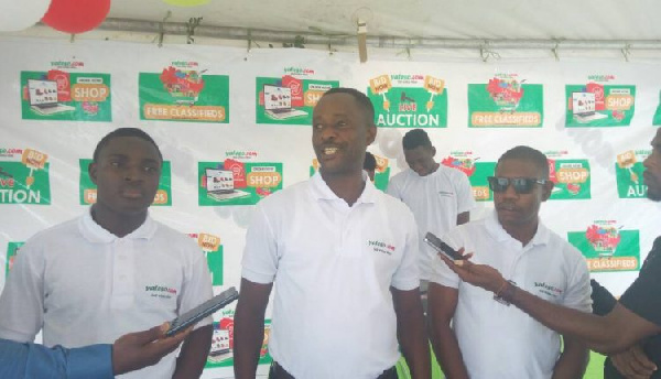 Mr. Israel Boateng (middle) addressing the media during the launch of the online portal