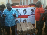 Kwabena Owusu-Aduomi (left) talking to the beneficiaries during a presentation