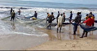 A photograph of fishermen performing their duties along the shores of small town in Ghana