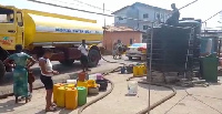 A  tanker delivering water to residents