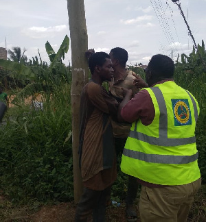 Men Trying To Prevent ECG Officials From Disconnecting Power Supply .jpeg