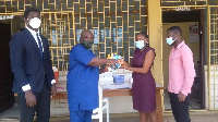 Mr. Kuranchie presenting samples of the two books to an official of the Osu Children’s Home.