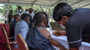 A Health Worker Administers A Covid Jab In Tanzania