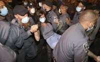 Isreali police arrest a demonstrator during a protest