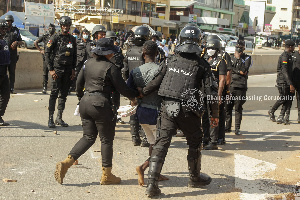 Police officers arrest a protester