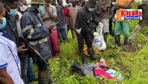 Police and community members at the site where the remains of the 2-year-old was found