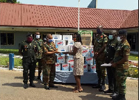 Brigadier General Nii Adjah Obodai, receiving the items from Patience Adzo Emeiabo on behalf o the