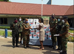 Brigadier General Nii Adjah Obodai, receiving the items from Patience Adzo Emeiabo on behalf o the