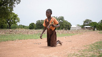 Agnes crawling on her knees to school