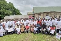 Members of ActionAid in a group photo with participants at an event at Kecheibi