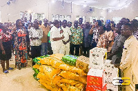 Reverend Wengam presenting the items to some of the victims