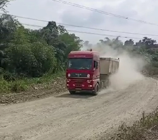 A GMC truck on the dusty road