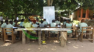 Students of Shai Senior High Technical School learning under a tree