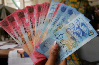 The cedi traded against the dollar at a mid-rate of 5.7512