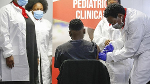 A healthcare worker administers a SINOVAC Covid-19 vaccine on a minor