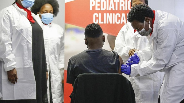 A healthcare worker administers a SINOVAC Covid-19 vaccine on a minor