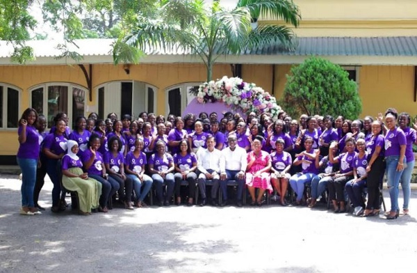 Female staff pose for a group picture after an annual workshop