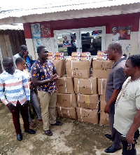 MP Paul Essien, handing the maths set to  Municipal Education Director, Geroge Effah