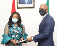 Madam Shirly Ayorkor Botchwey (left) receiving the documents from Mr Wamkele Mene