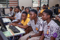 Some students behind some computers