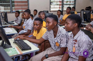 Some students behind some computers