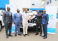 Tornam Sapati, Dep. head, credit risk (2nd right) receives keys from Francis Kojo Kujoji (3rd left)