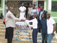 The Parliamentary hopeful (right) donating the items to a staff of the clinic