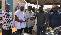 Abdul Jabar receiving a brand new motorbike from Alhassan S. Suhuyini