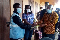 Nana Kwasi Owusu-Yeboa distributing the items at the registration centre