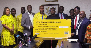 Staff of MTN presenting the cheque to board members SSNIT