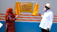 Samia Suluhu (L) claps as Ugandan Yoweri Museveni unveils the Kikagati-Murongo Hydropower Plant