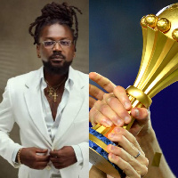 Ghanaian musician, Samini (L) AFCON trophy (R)